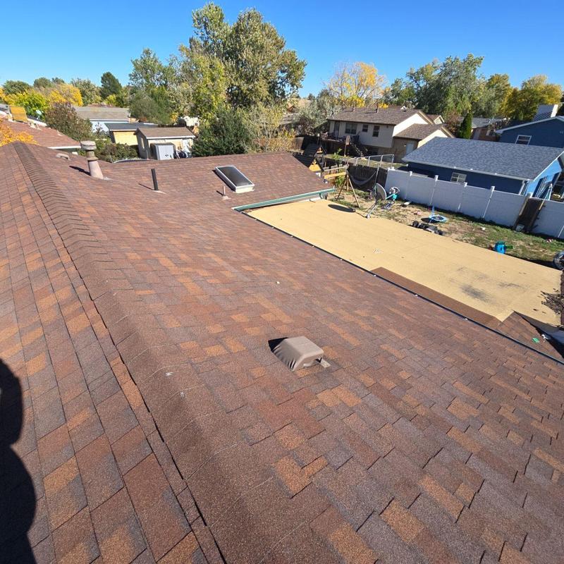 Asphalt shingle roof with hail damage and vent pipe