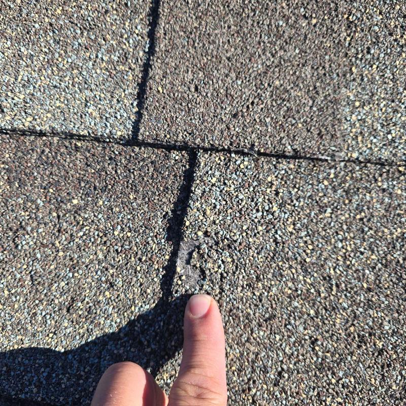 Asphalt shingle roof with hail damage after 2023 storm