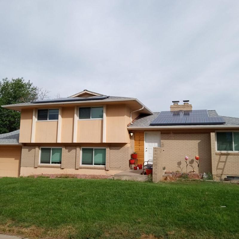Solar panel and shingle roof installation on house