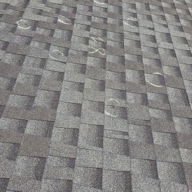 Asphalt shingle roof with hail damage marks