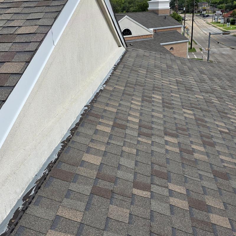 Asphalt shingle roof with metal flashing and gutter system