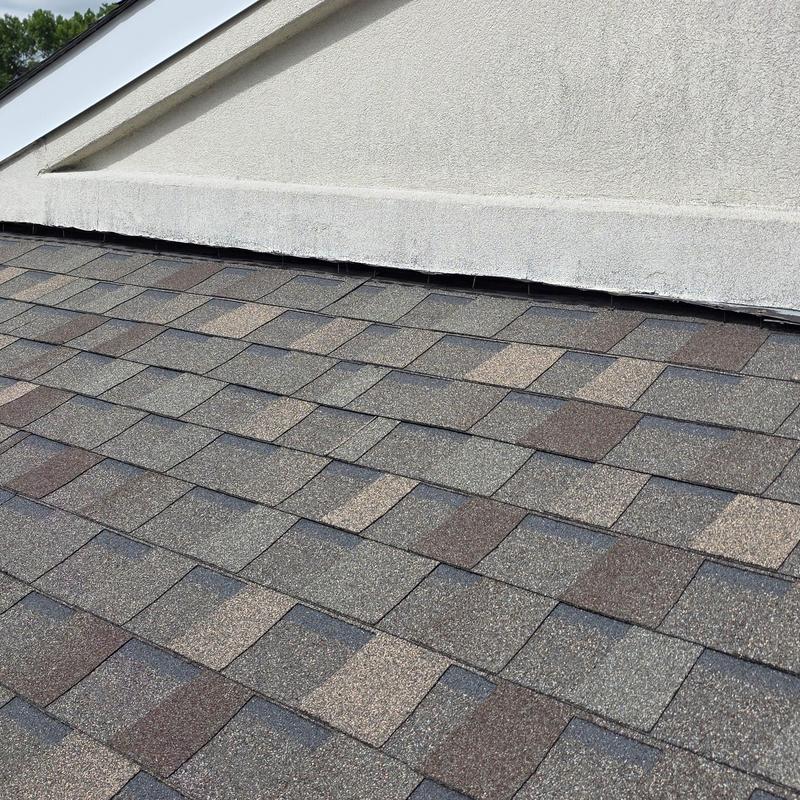 Asphalt shingle roof inspection for hail damage near wall