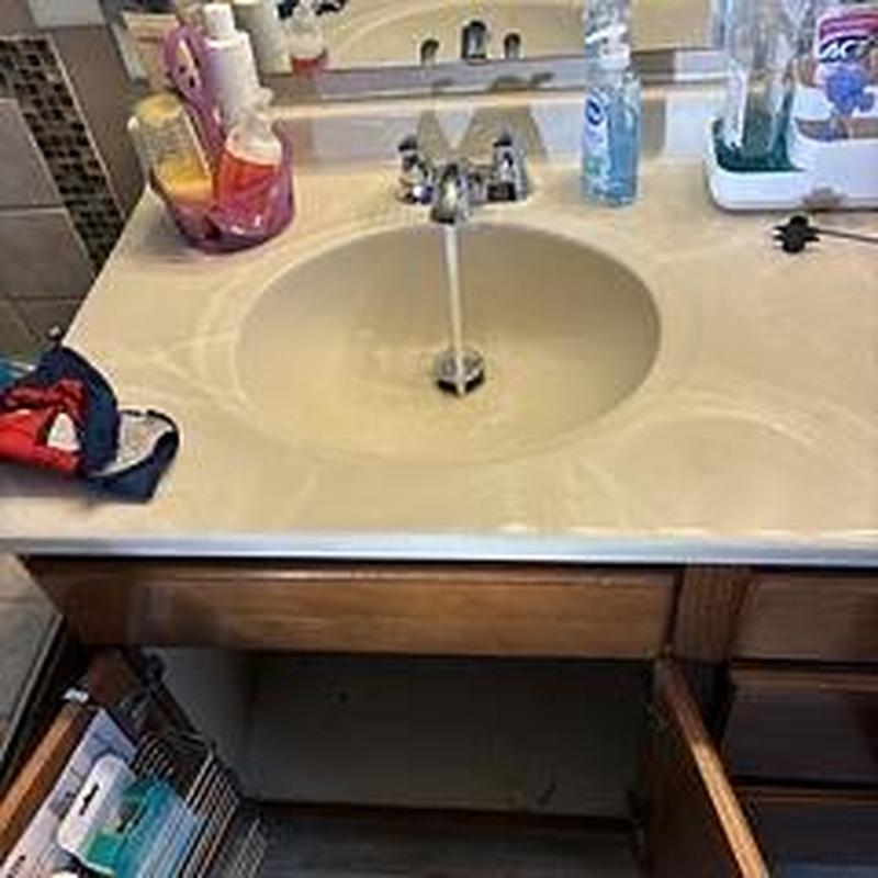 Lavatory faucet with running water in bathroom sink