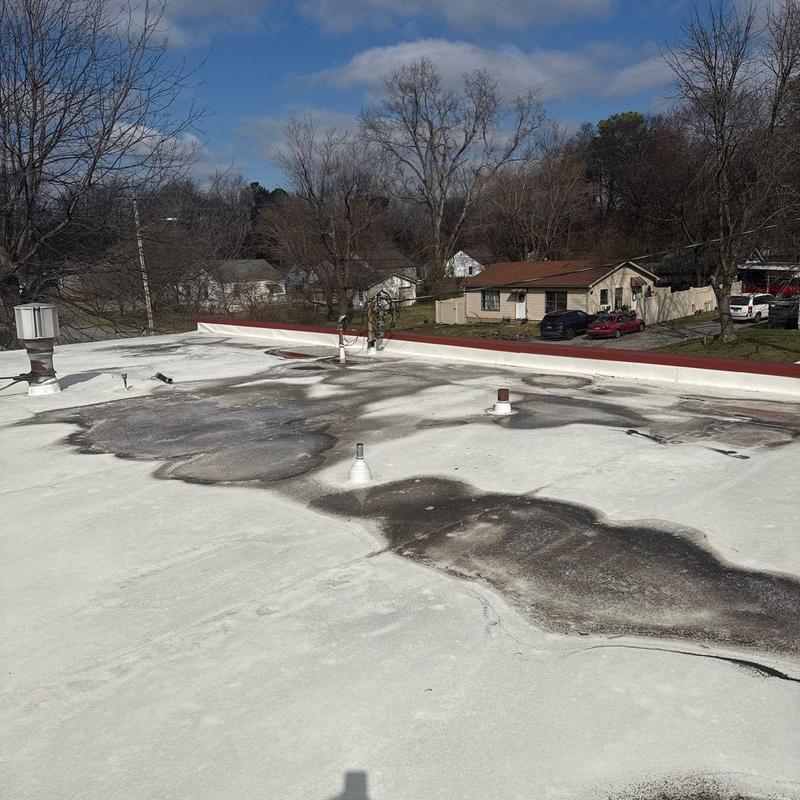Flat roof membrane with extensive water damage patches