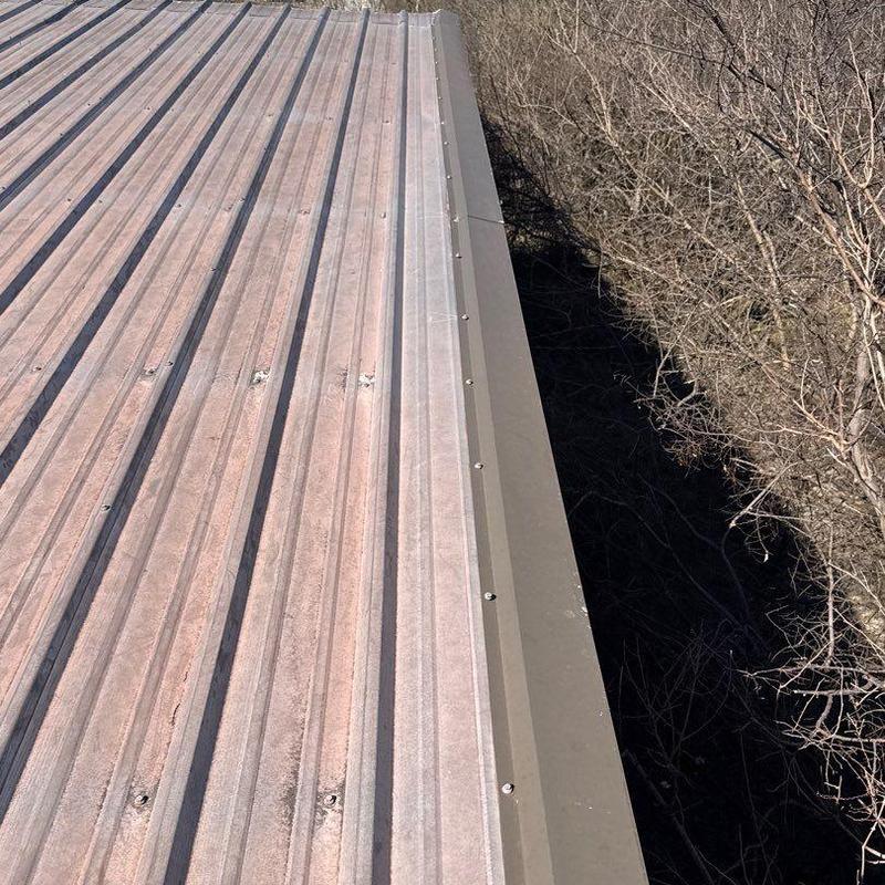 Metal roof panels and edge flashing with hail damage