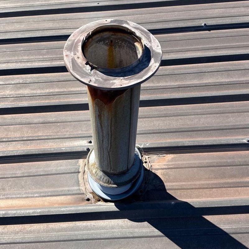 Metal roof vent pipe with rust and damage