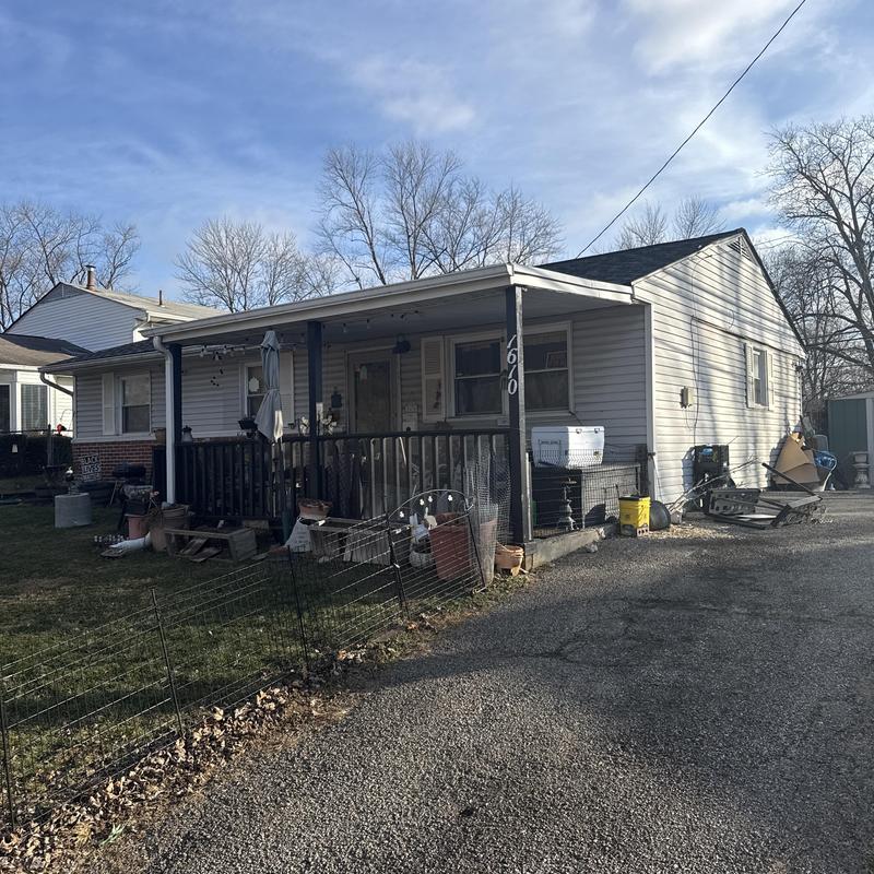 Roof and gutter inspection on single-story house exterior Roof and gutter inspection on single-story house exterior