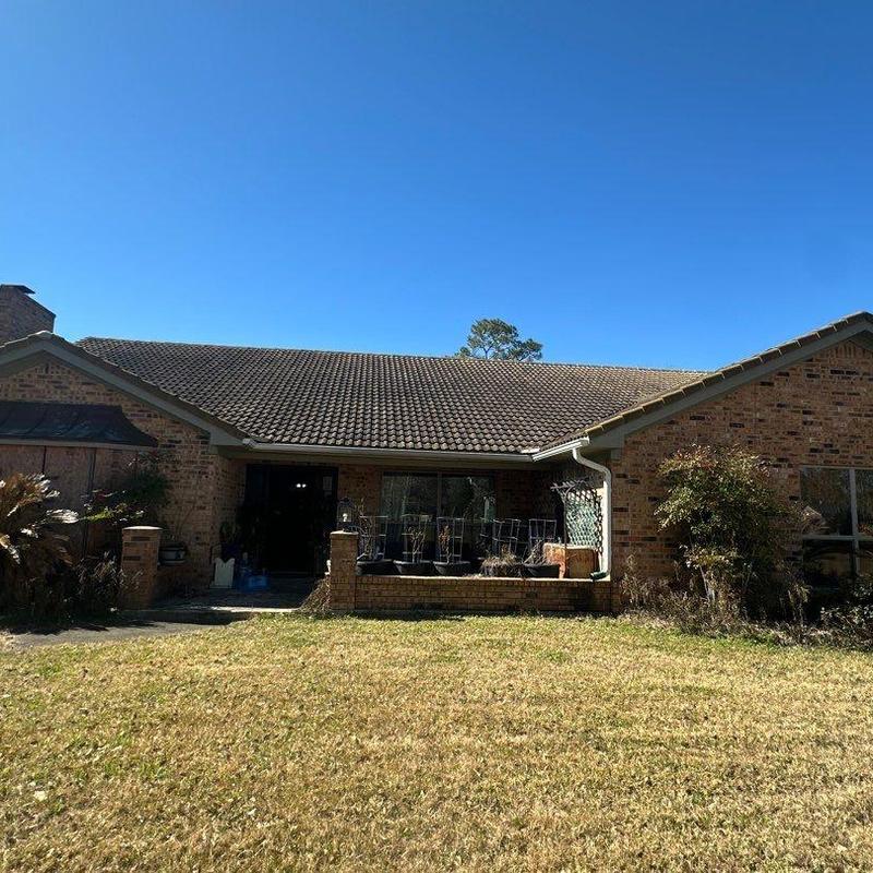 Tile roof with aging clay tiles on brick home Tile roof with aging clay tiles on brick home