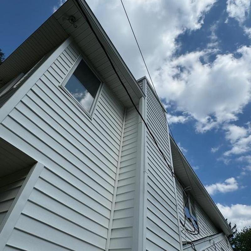 Vinyl siding repair on residential building exterior Vinyl siding repair on residential building exterior