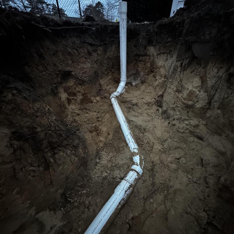 PVC sewer pipe replacement in excavated trench