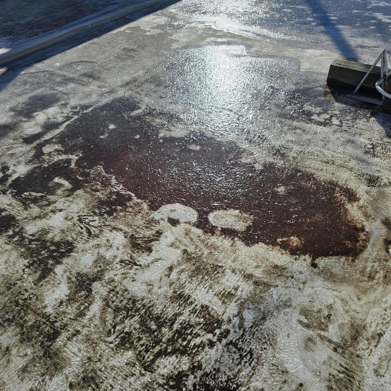 Flat roof membrane with standing water and stains