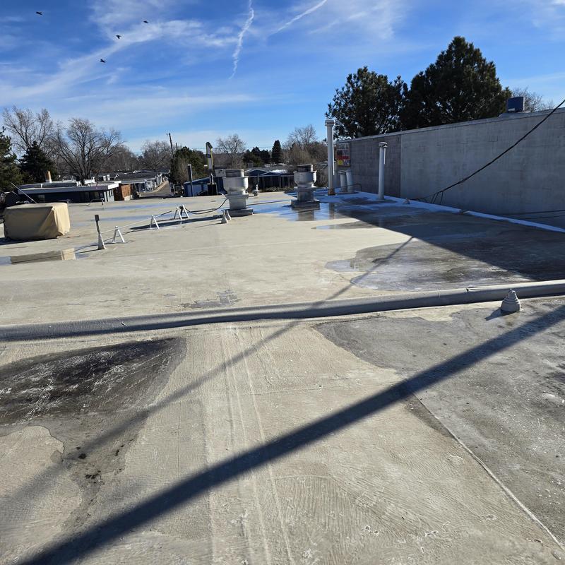 Flat roof with active leaks and damaged seams