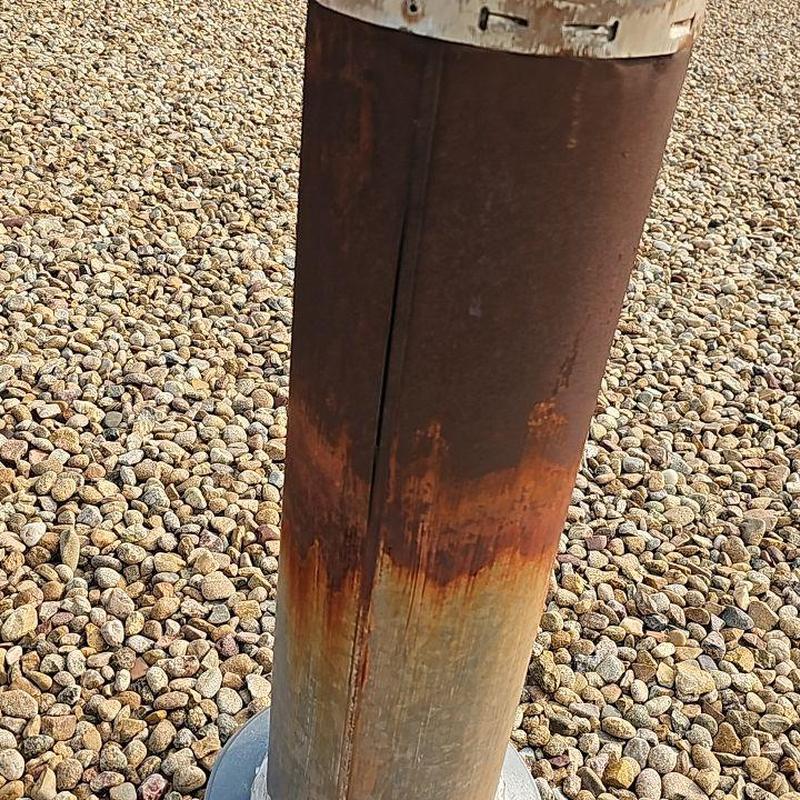 Rusted 6-inch pipe on commercial flat ballasted roof Rusted 6-inch pipe on commercial flat ballasted roof