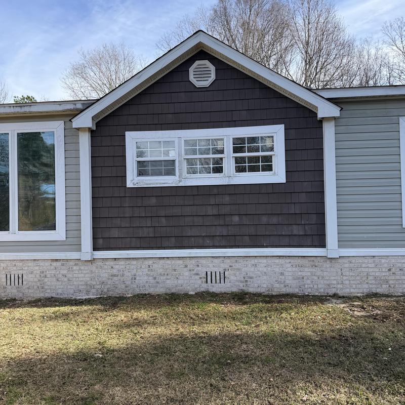 Broken window replacement on exterior wall siding Broken window replacement on exterior wall siding