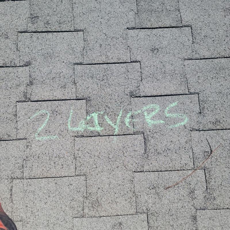 T-Lock shingles with chalk mark "2 Layers" on roof T-Lock shingles with chalk mark "2 Layers" on roof
