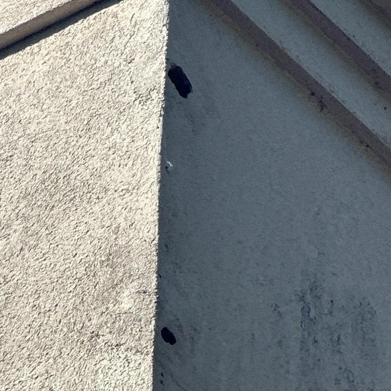Roof exterior stucco with visible holes and damage