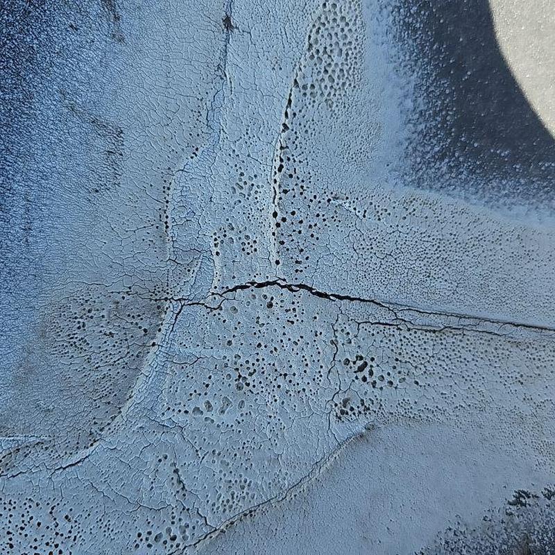 EPDM roof with cracked elastomeric coating damage EPDM roof with cracked elastomeric coating damage