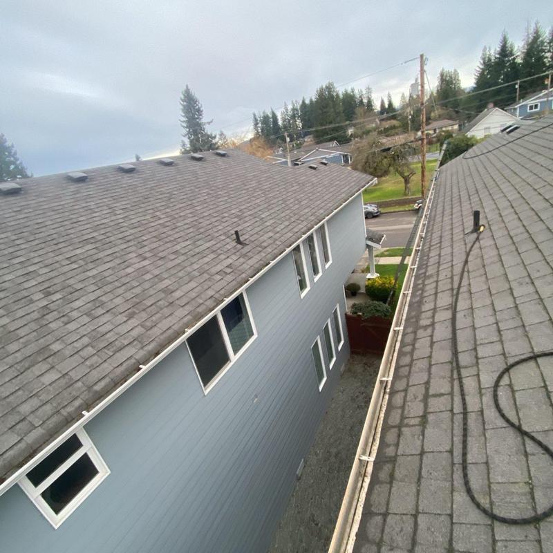 Gutter system cleaning on residential roof in Arlington