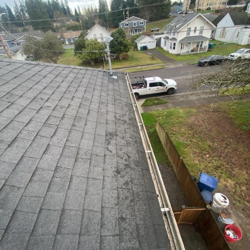 Gutter cleaning and debris removal on roof edge