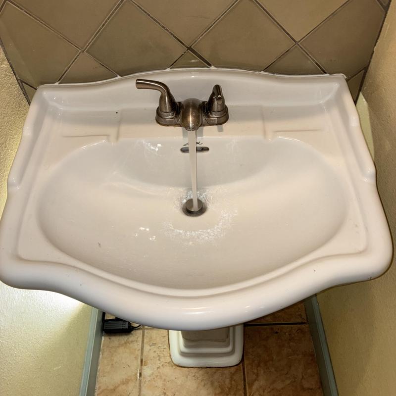 Pedestal sink with running faucet and drain assembly