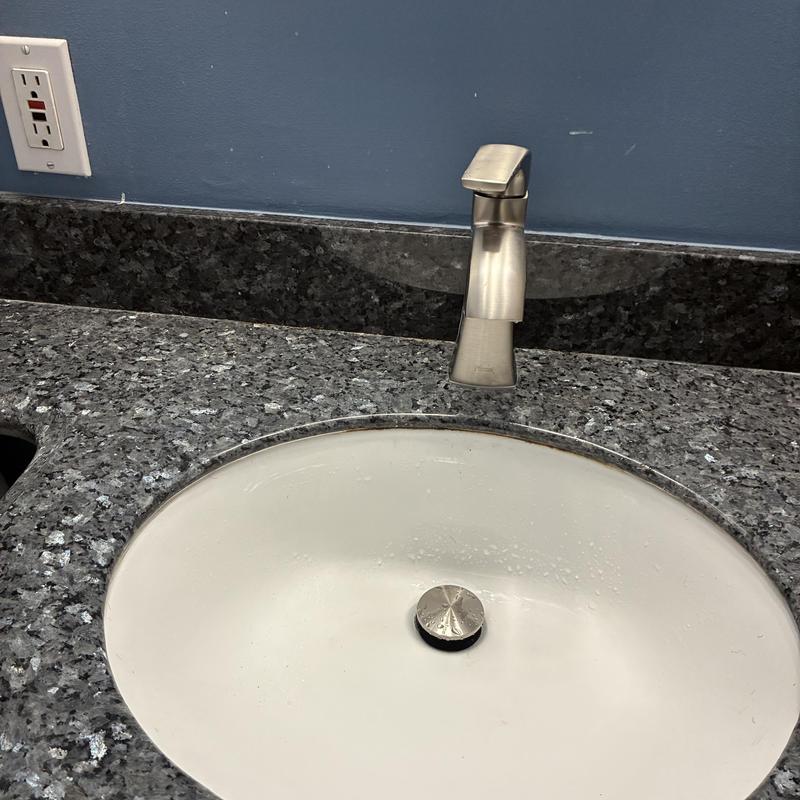 Basin faucet installation on granite countertop with sink