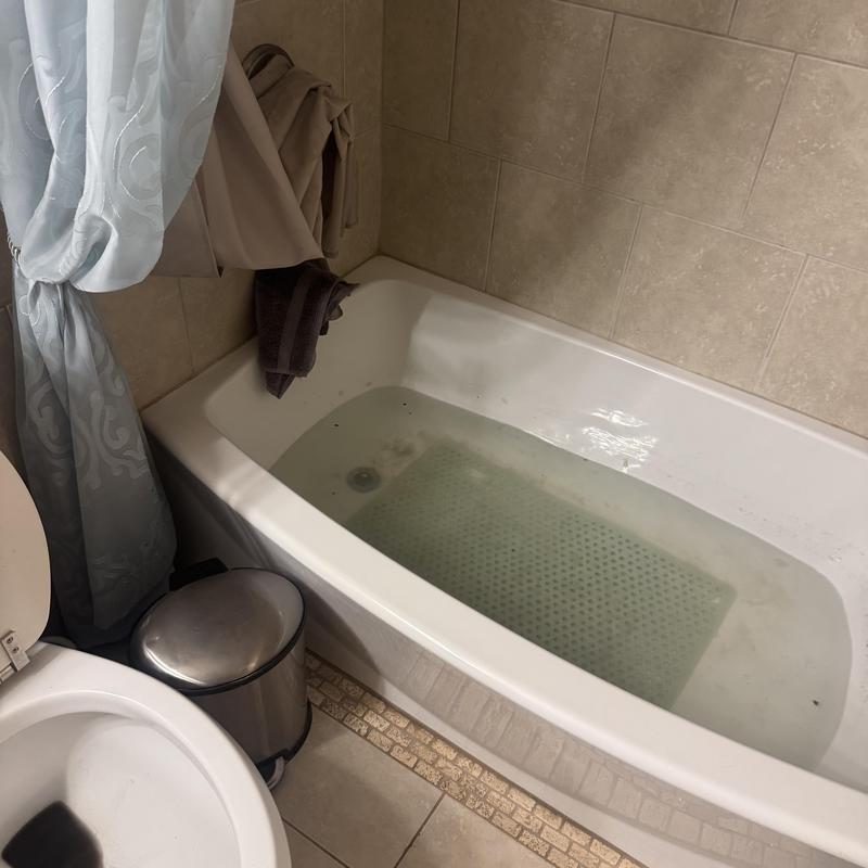 Cast-iron drain pipe cleaning with water backup in bathtub