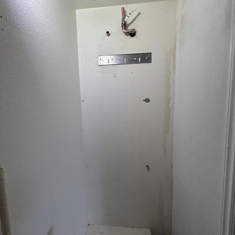 Tankless water heater wall plumbing setup