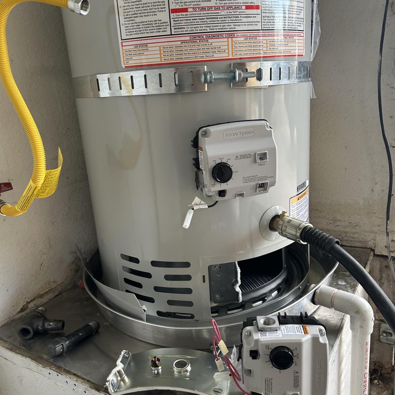 Gas water heater with control unit removed for service