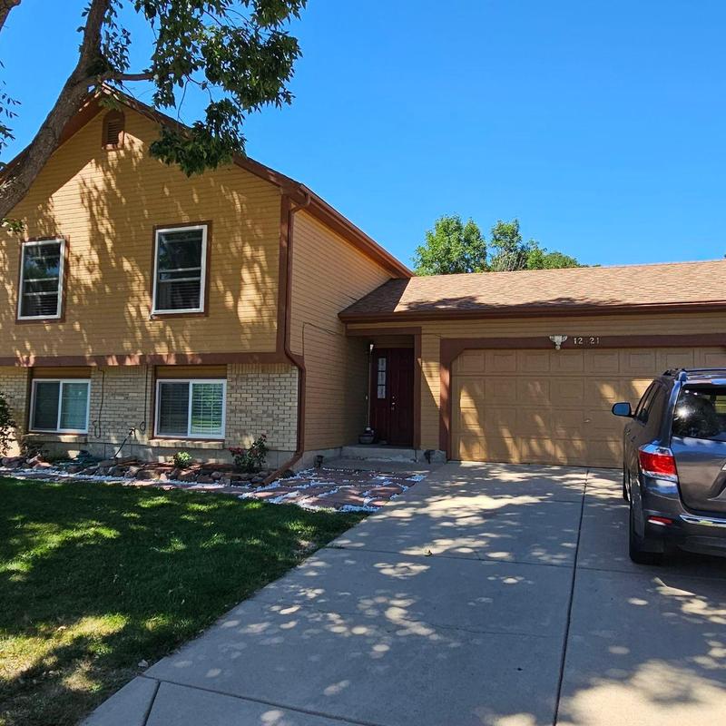 Shingle roof with hail damage on suburban home Shingle roof with hail damage on suburban home