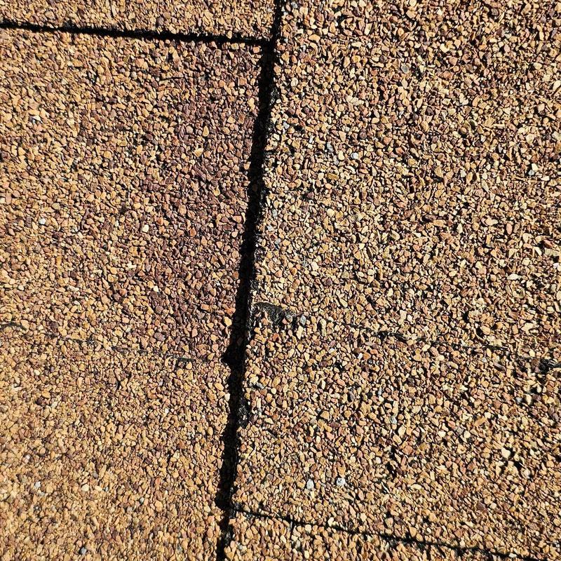Shingle roof close-up showing hail damage granules Shingle roof close-up showing hail damage granules