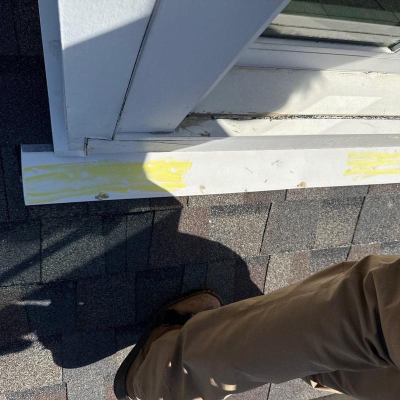 Window flashing on asphalt shingle roof with damage marks