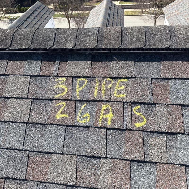 Roof shingles with marked hail damage on ridge spine