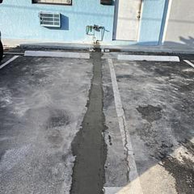 Main water service trench patched with asphalt and concrete