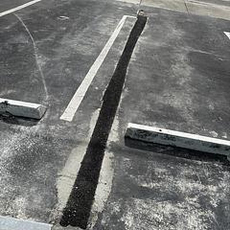 Galvanized water main trench cut and sealed in asphalt