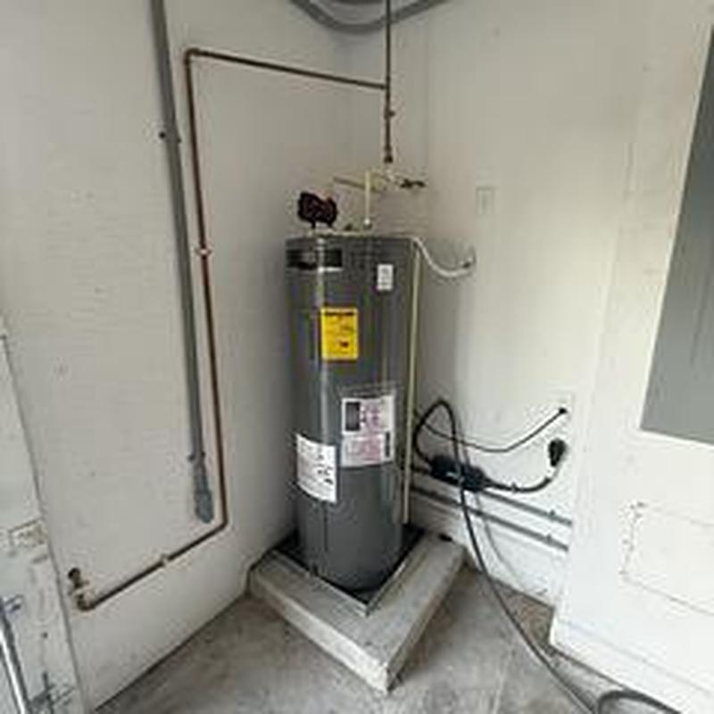 Water heater Rheem 50-gallon installed in corner