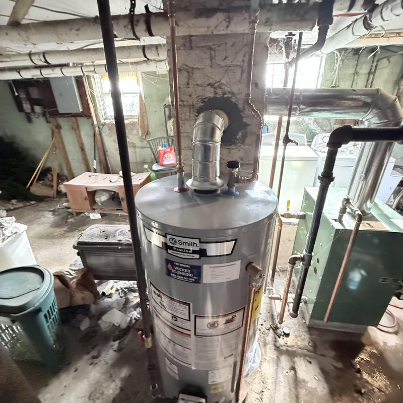 Gas water heater replacement with vent pipe installation