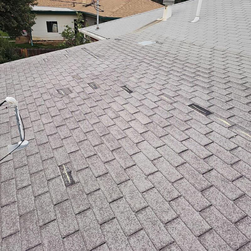Shingle roof with hail and wind damage markings Shingle roof with hail and wind damage markings