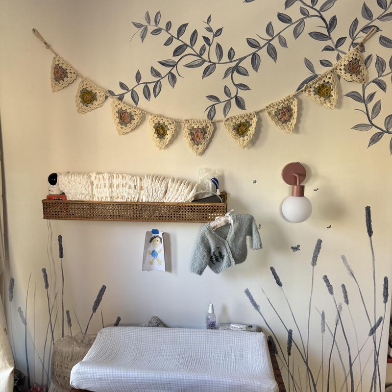 Nursery changing station with wall shelf and decor