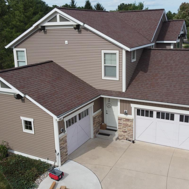 Vinyl siding with stone accents on residential home Vinyl siding with stone accents on residential home