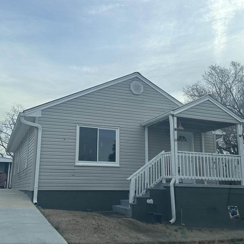 Vinyl siding and porch with railing on residential house