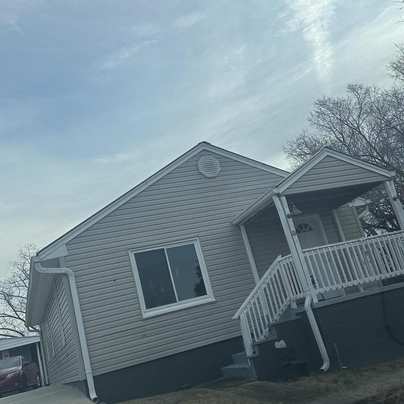 Metal and shingle roof on residential house exterior
