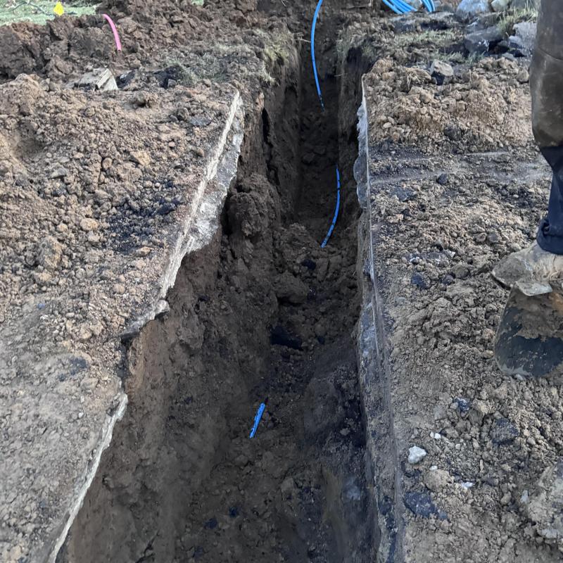1-inch water service poly pipe with tracer wire in trench