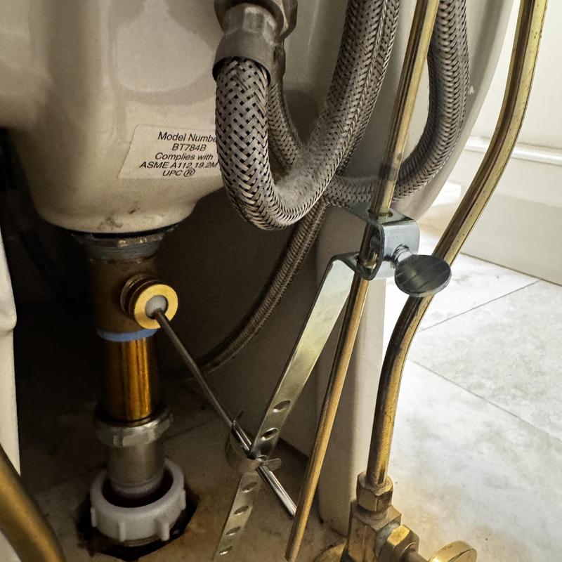 Polished brass bidet pop-up assembly installation