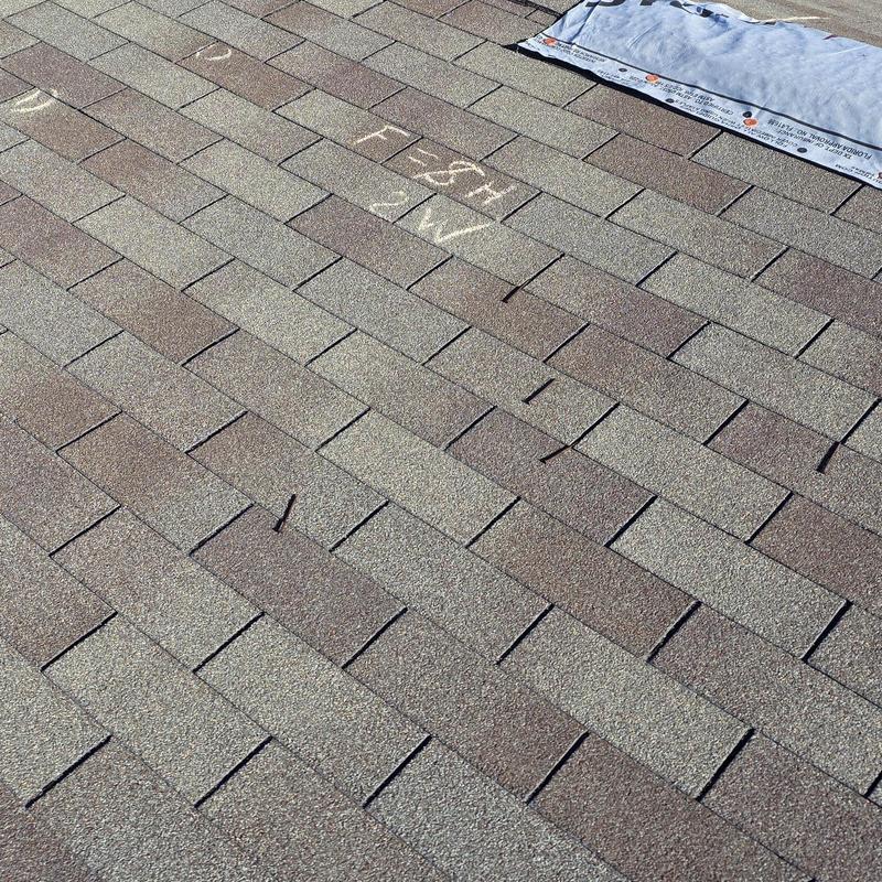 Asphalt shingle roof with chalk markings for hail inspection