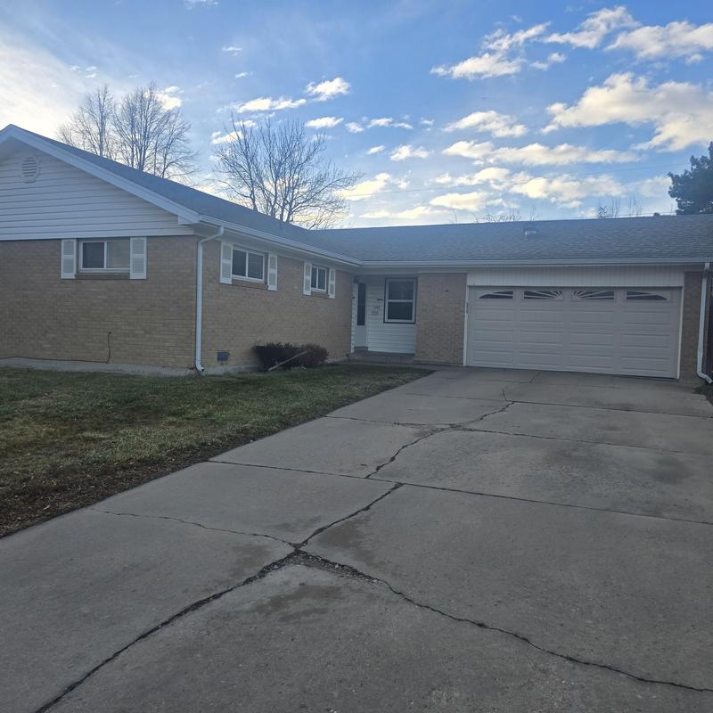 Shingle roof with hail damage on suburban home Shingle roof with hail damage on suburban home
