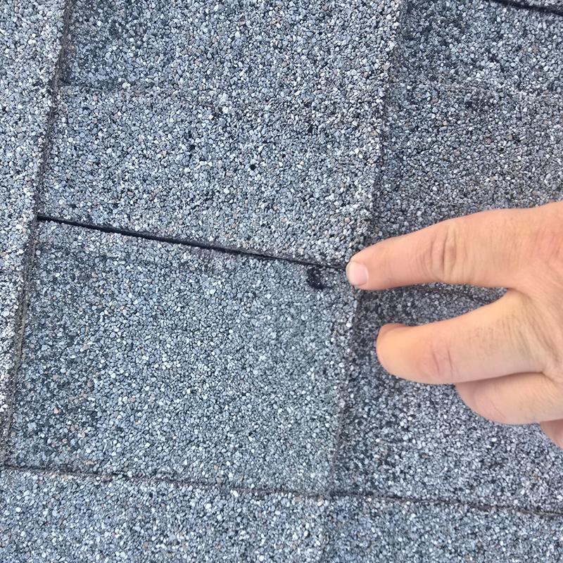 Asphalt shingle roof with hail damage spot detail Asphalt shingle roof with hail damage spot detail