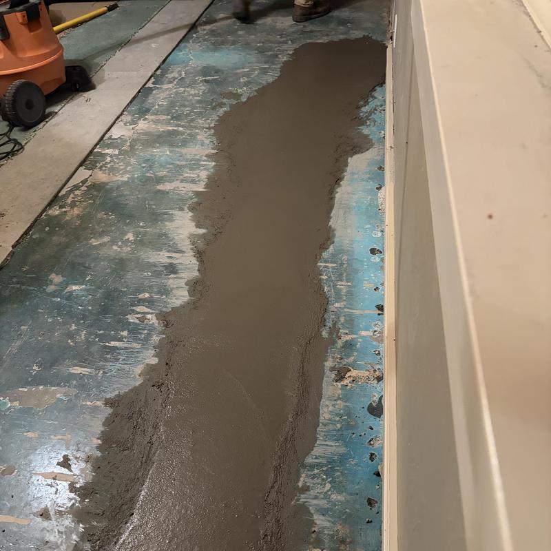 Cast iron kitchen drain pipe patch with cement layer