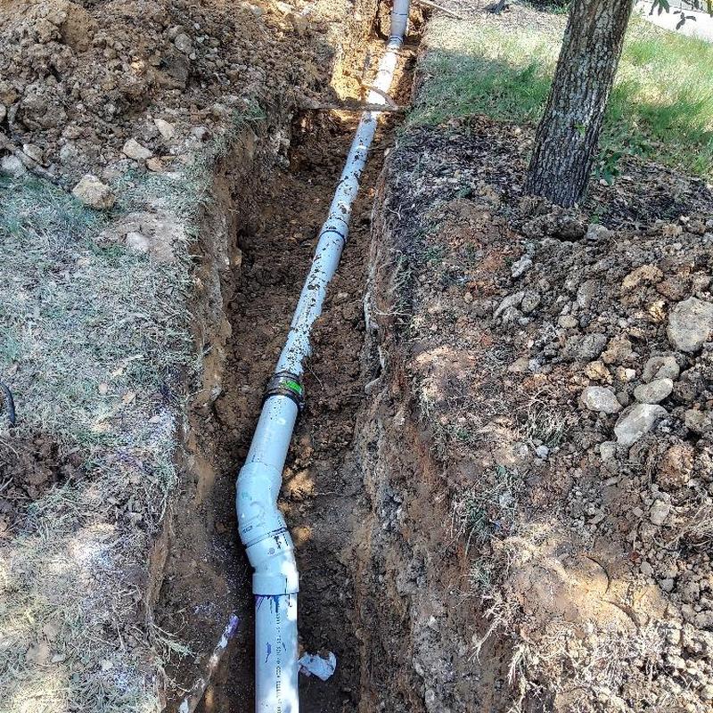 Sanitary sewer line with new pipe in trench