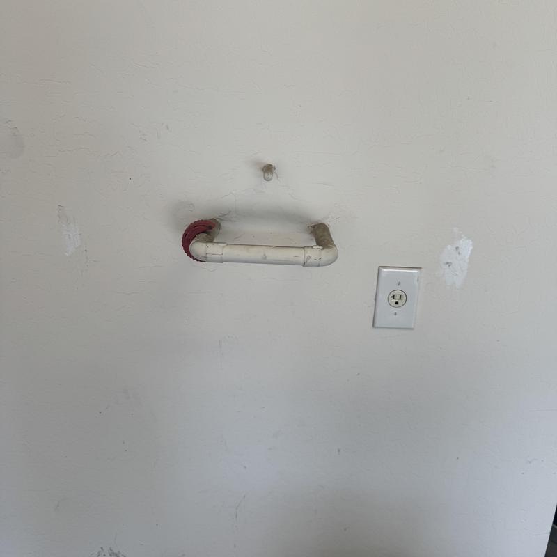 Water softener supply pipe with wall electrical outlet