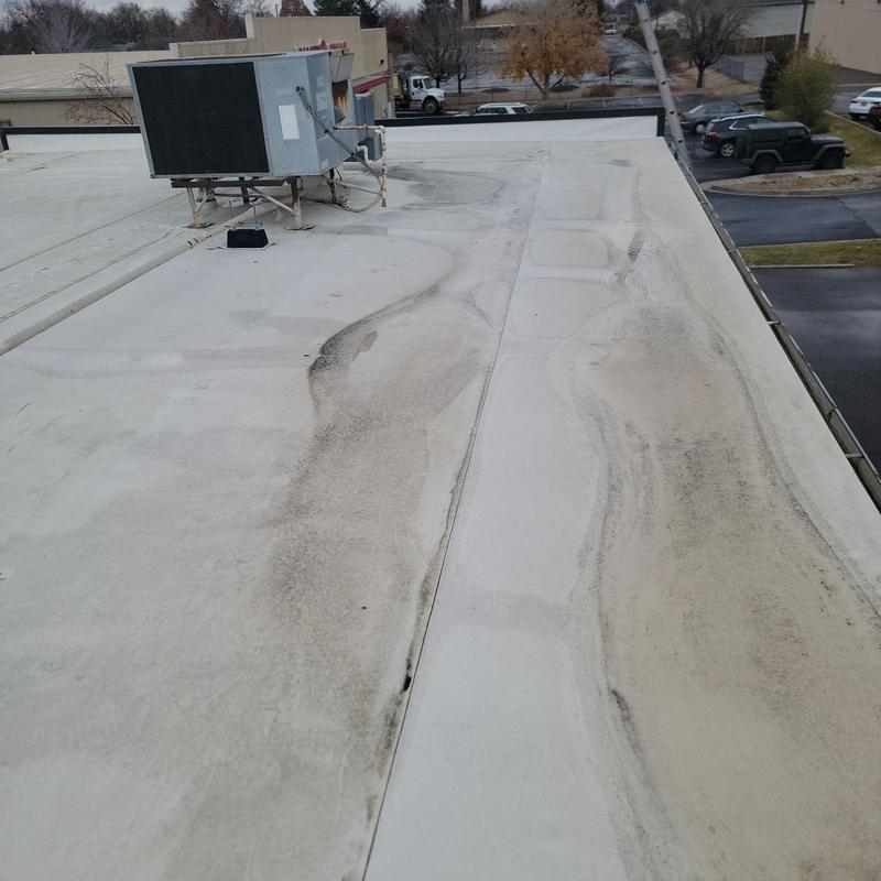 TPO flat roof with HVAC unit and dirt streaks TPO flat roof with HVAC unit and dirt streaks